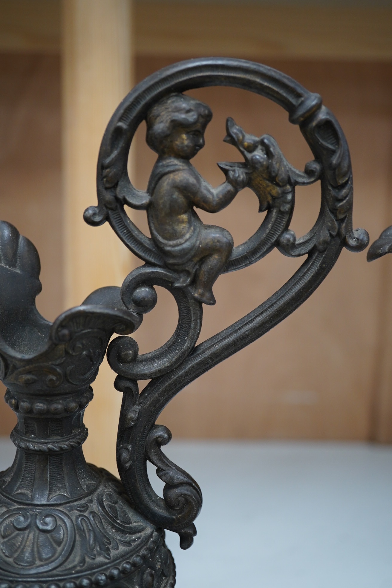 A pair of spelter Cellini ewers, 34.5cm high. Condition - fair to good, some general wear overall